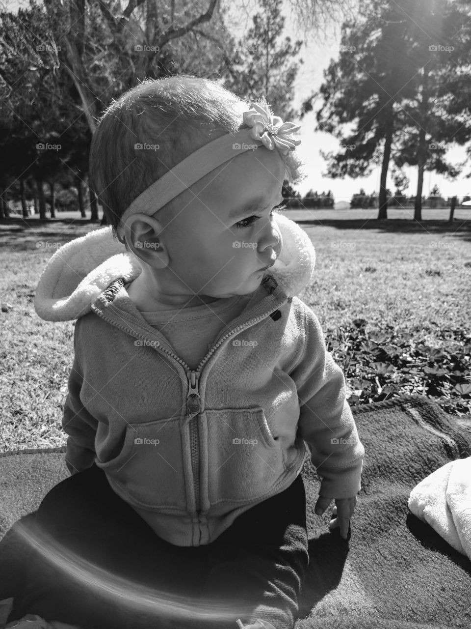 Little girl sitting in park