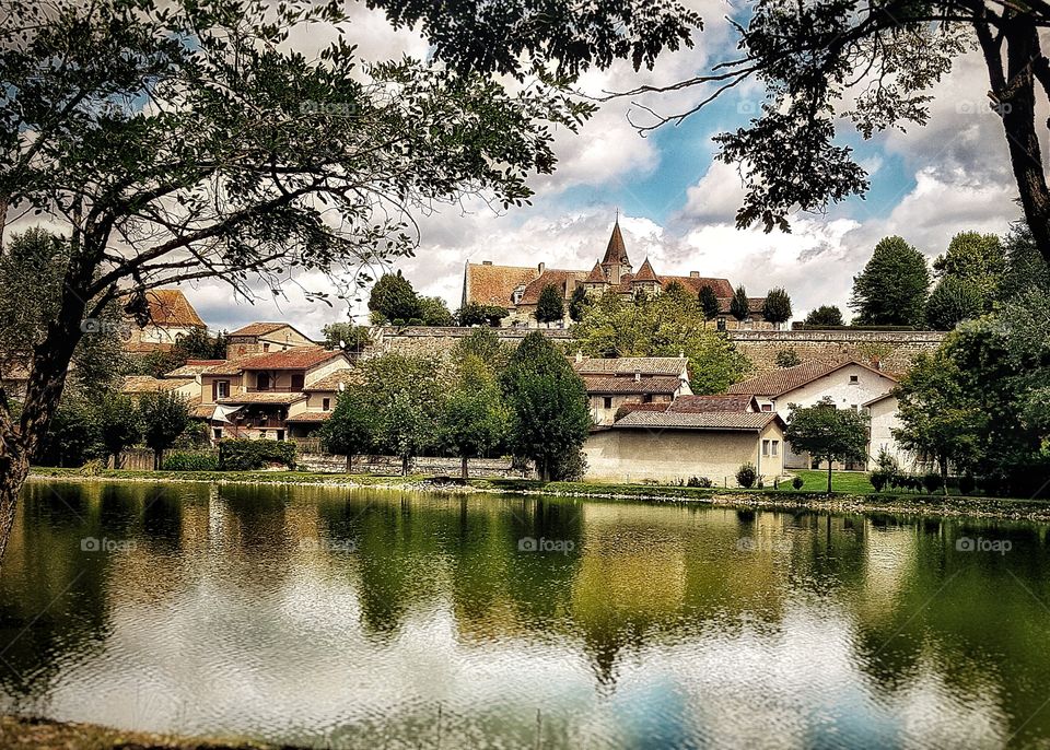 Château in Lauzun, France, reflected in the lake