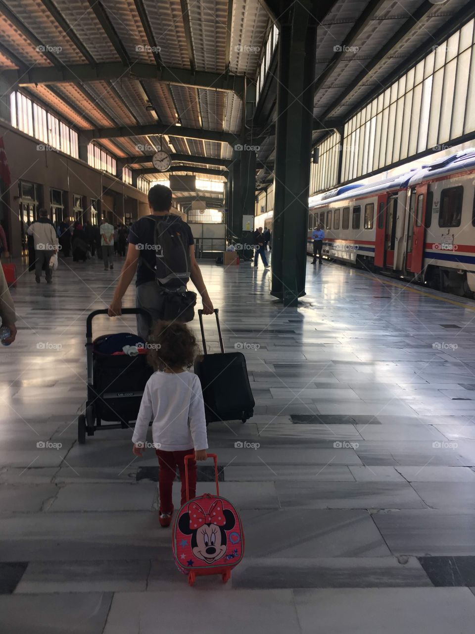 A dad a girl and suitcases