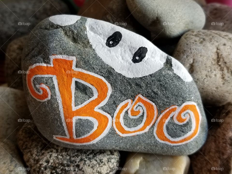 Boo with ghost painted on rock