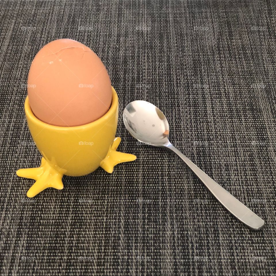 Breakfast - boiled egg With yellow chicken legs and spoon