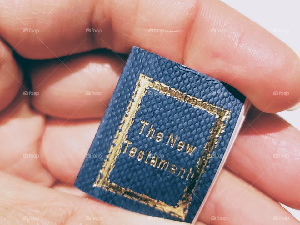 Close up of holding a real miniature bible