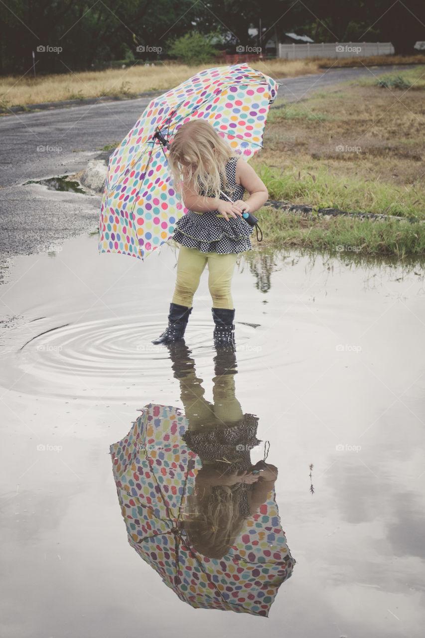 Toddler playing in the rain