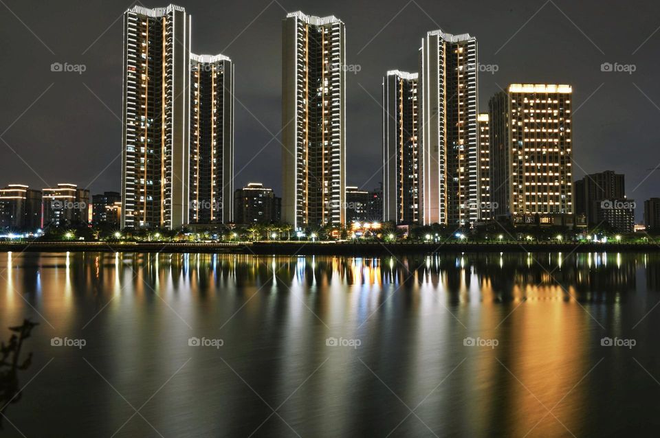 Beautiful reflection of high buildings in water at evening time 