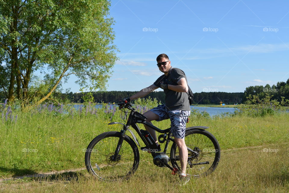 men ridding on a bike summer time