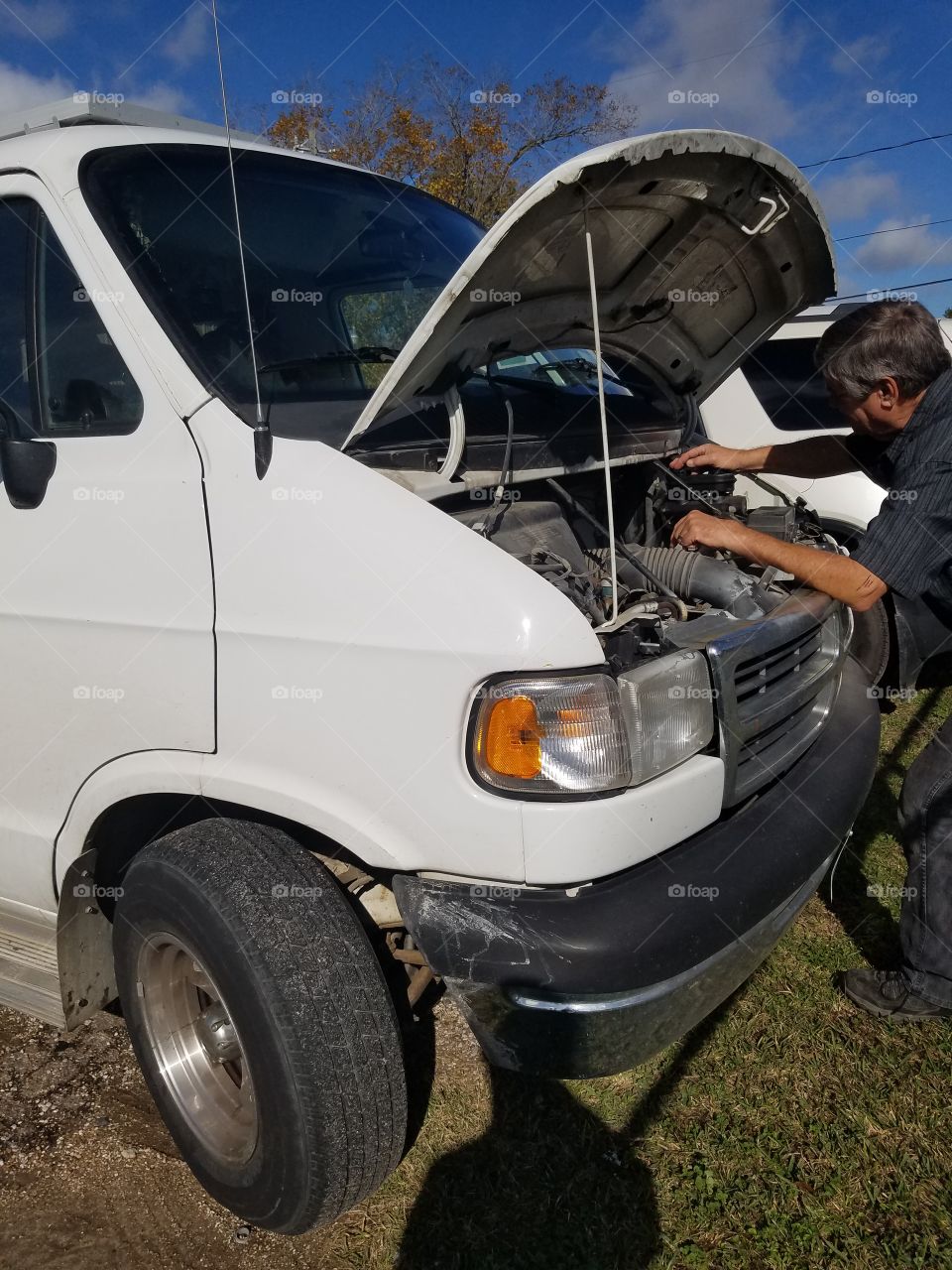 Mechanic working under the hood of a van