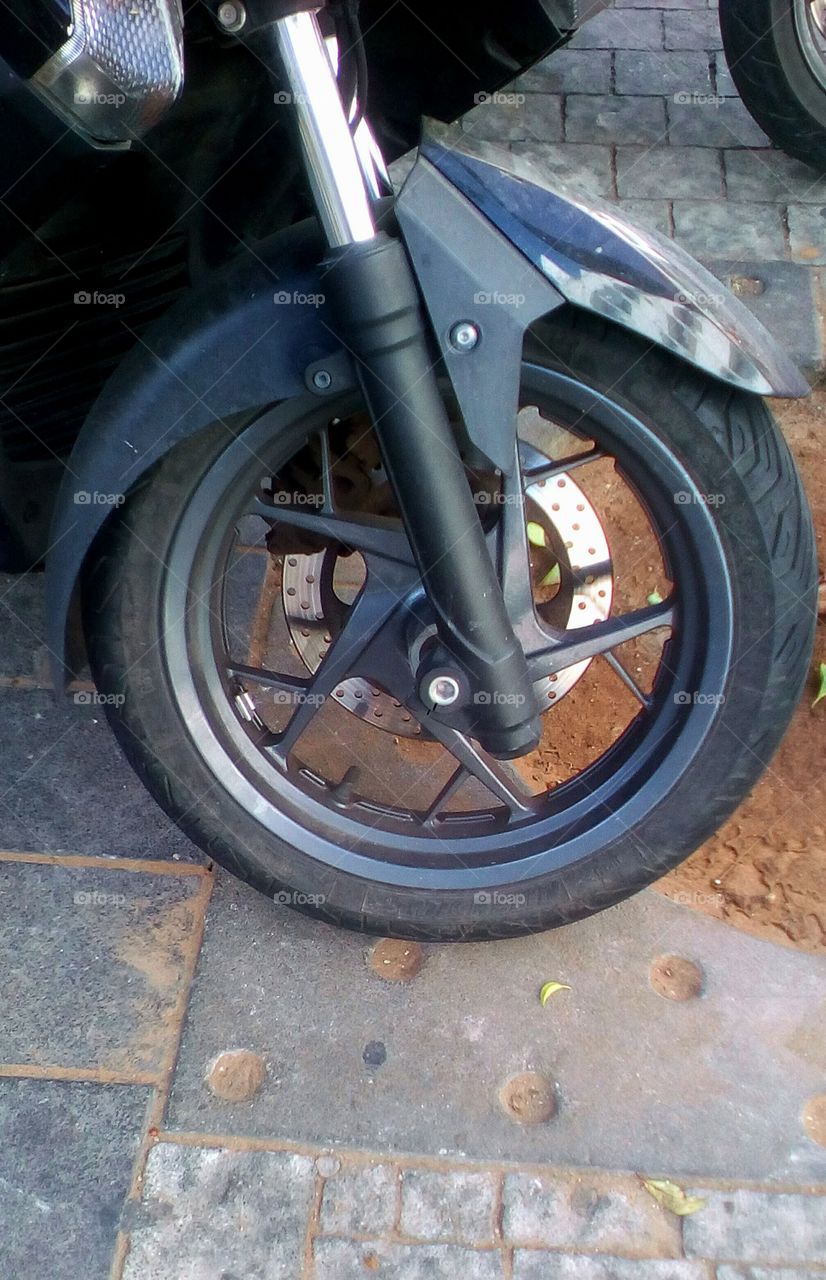Motorcycle wheel in street in natural
color