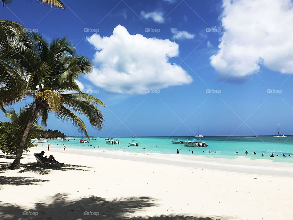 People enjoying the tropical vacation at the paradise island sandy beach 