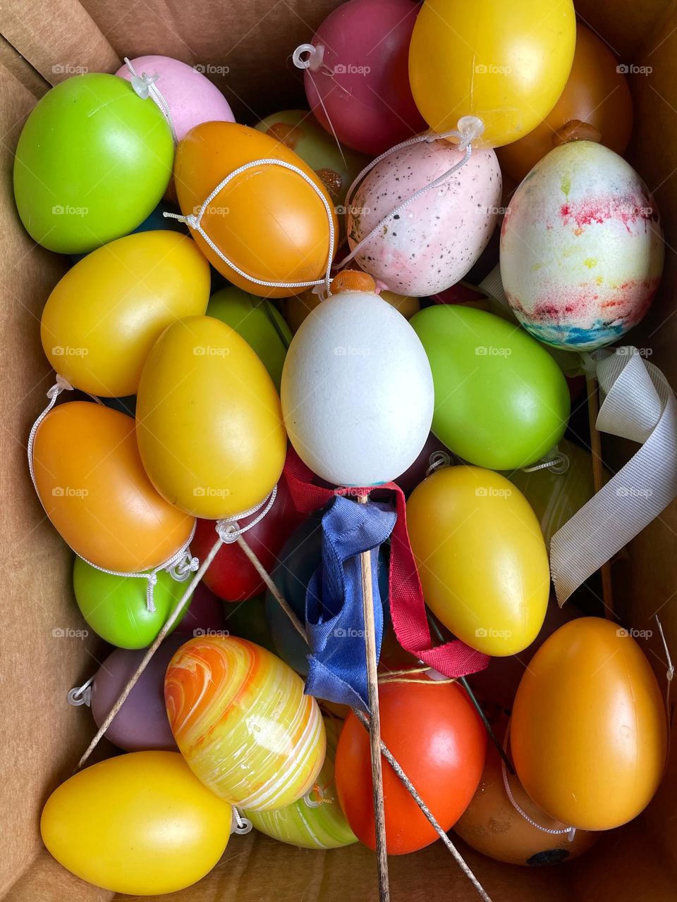 Close-up of many colorful Easter eggs in a box