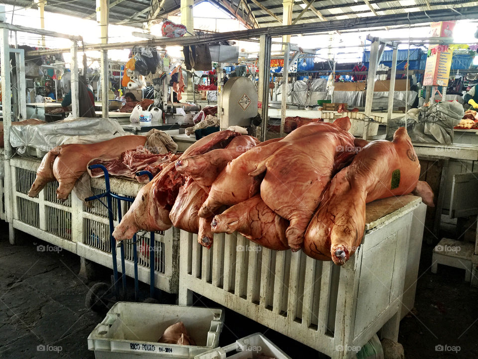 Pork on display in local market, Cuzco Peru