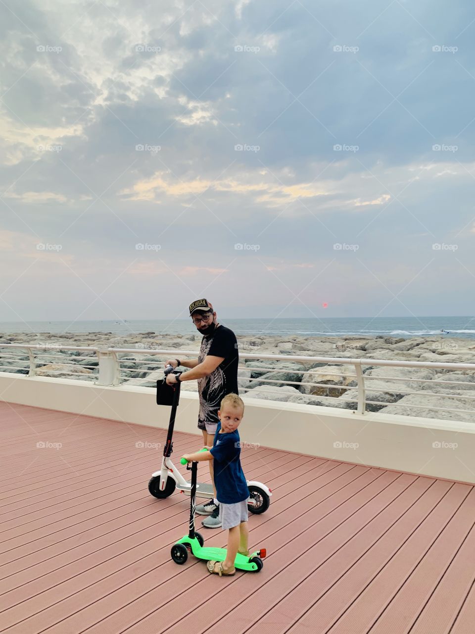 Father and son driving scooters 