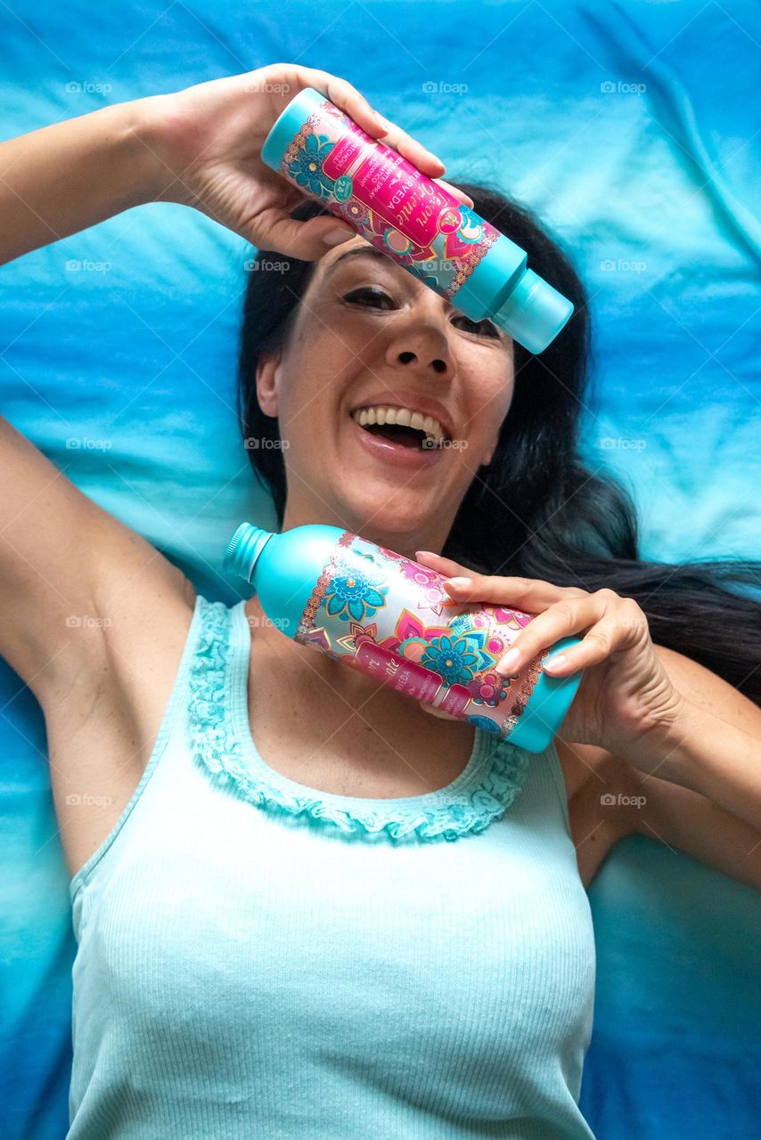 Energetic, Light - Hearted Portrait of Beautiful Smiling Woman with Products