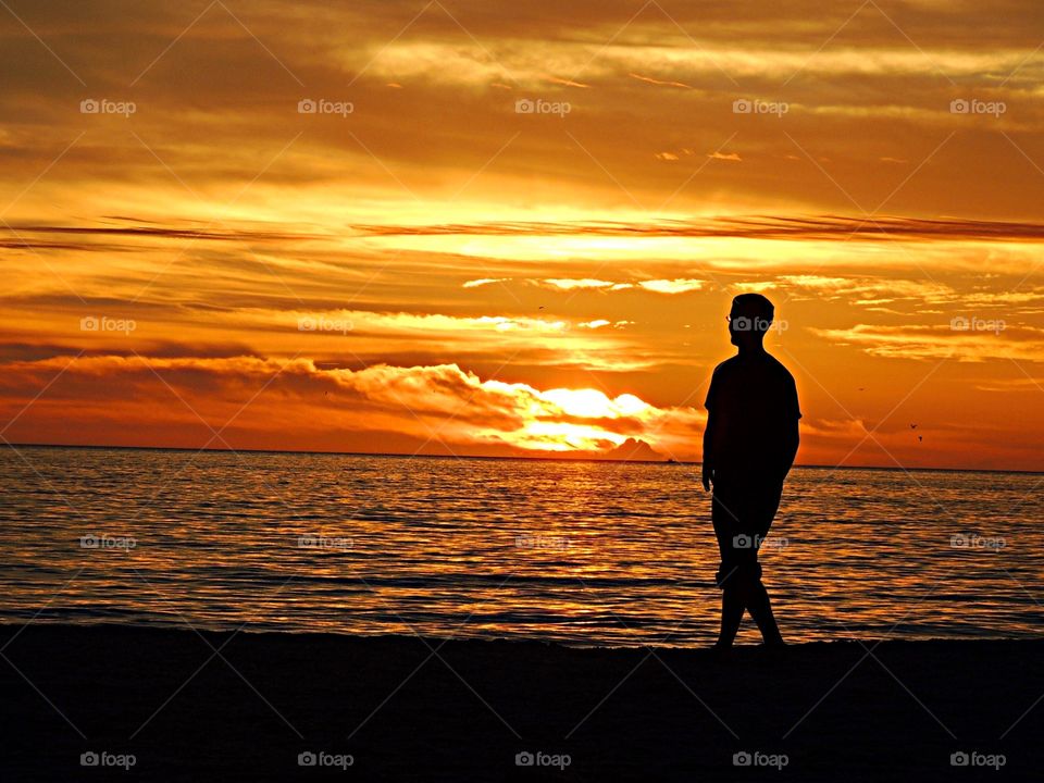 Silhouette of person on sandy beach