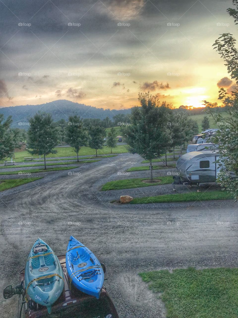 View from the top of our camper at sunset which includes the mountains and our kayaks 