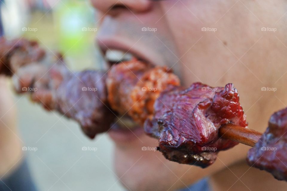 Eating meat. Close up