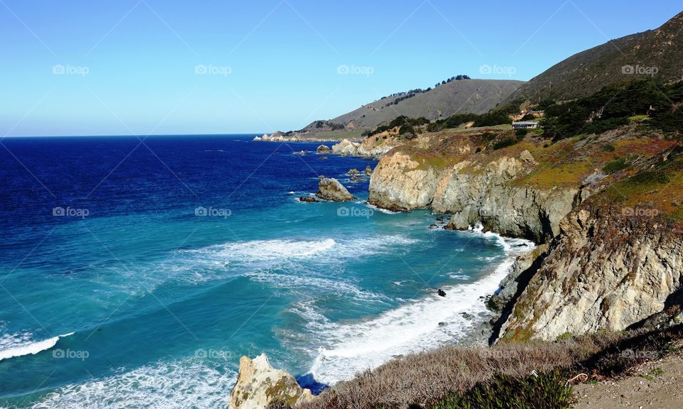 Blue sea against blue sky