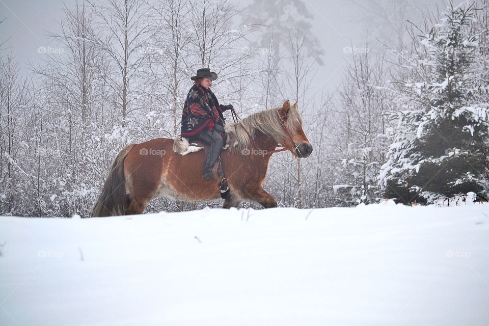 Woman riding her horse