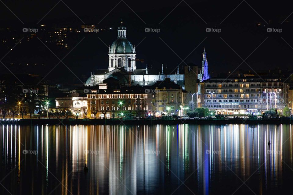 Nightscape in Como with its cathedral and thousand lights that are reflected in the lake.