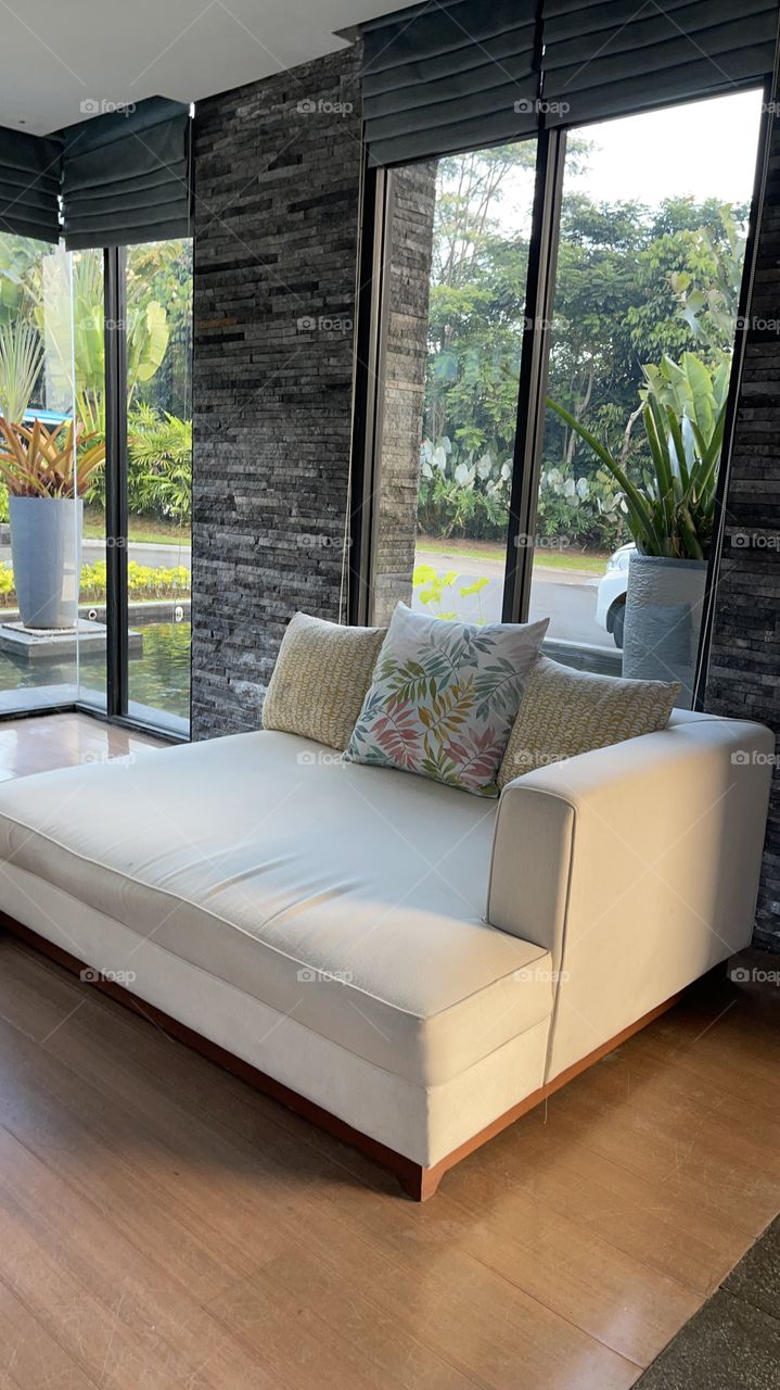 Living room with three seater sofa in the corner