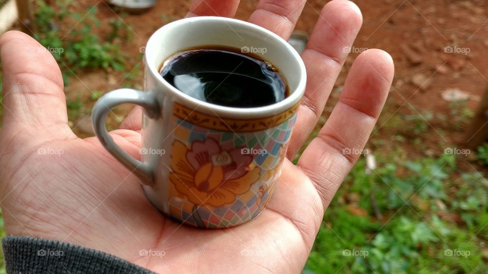 Person holding cup of coffee