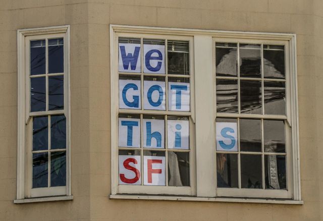 Window in San Francisco during the pandemic with a message of encouragement and support in the window 