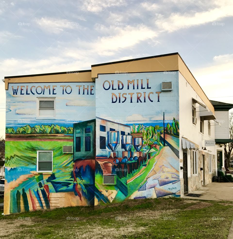 Front view Welcome to Old Mill District Painting on Building