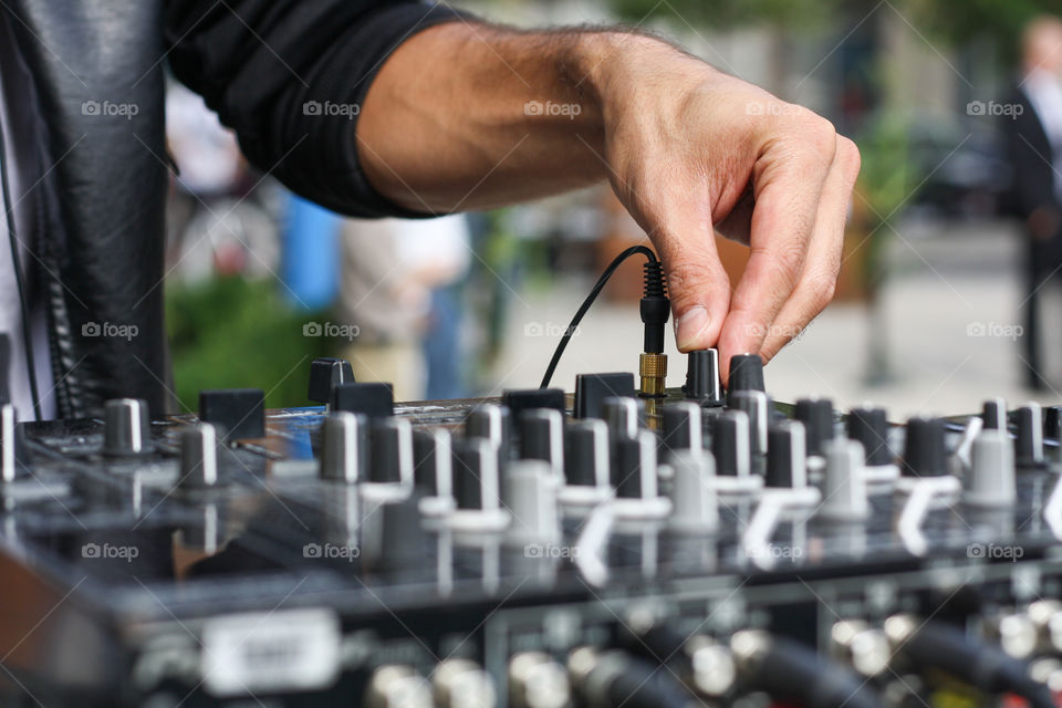 A DJ adjusts the sound at an outdoor party