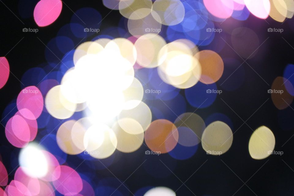 Golden lights flash as the buildings at the Perth royal show shine amongst the fireworks 