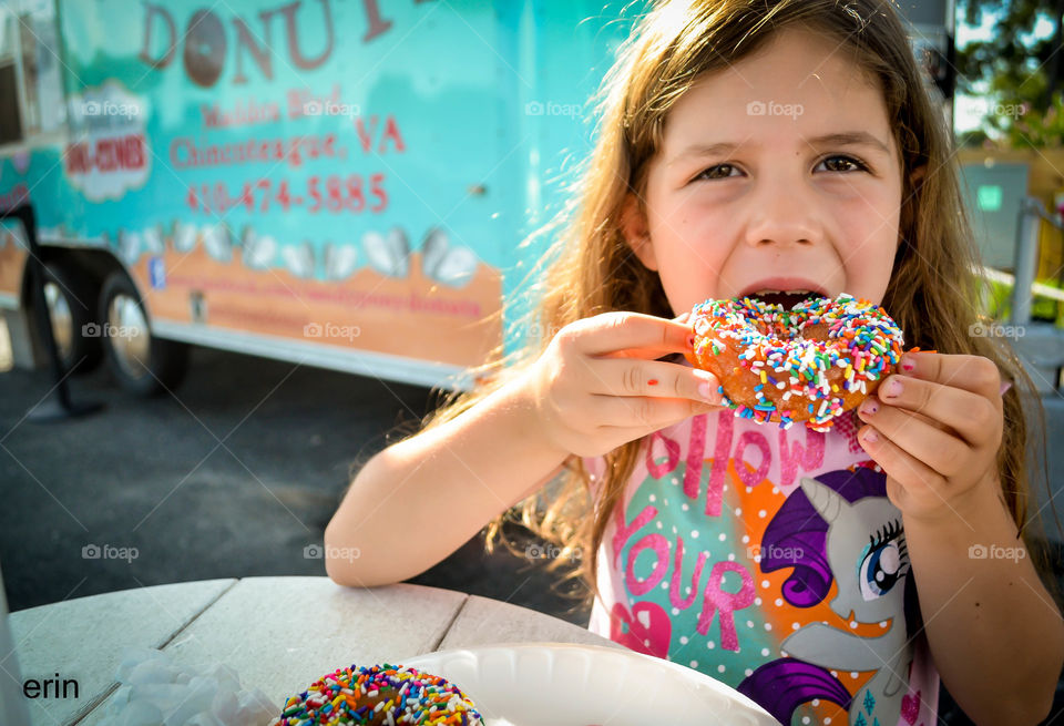 Little girl eating donuts 
