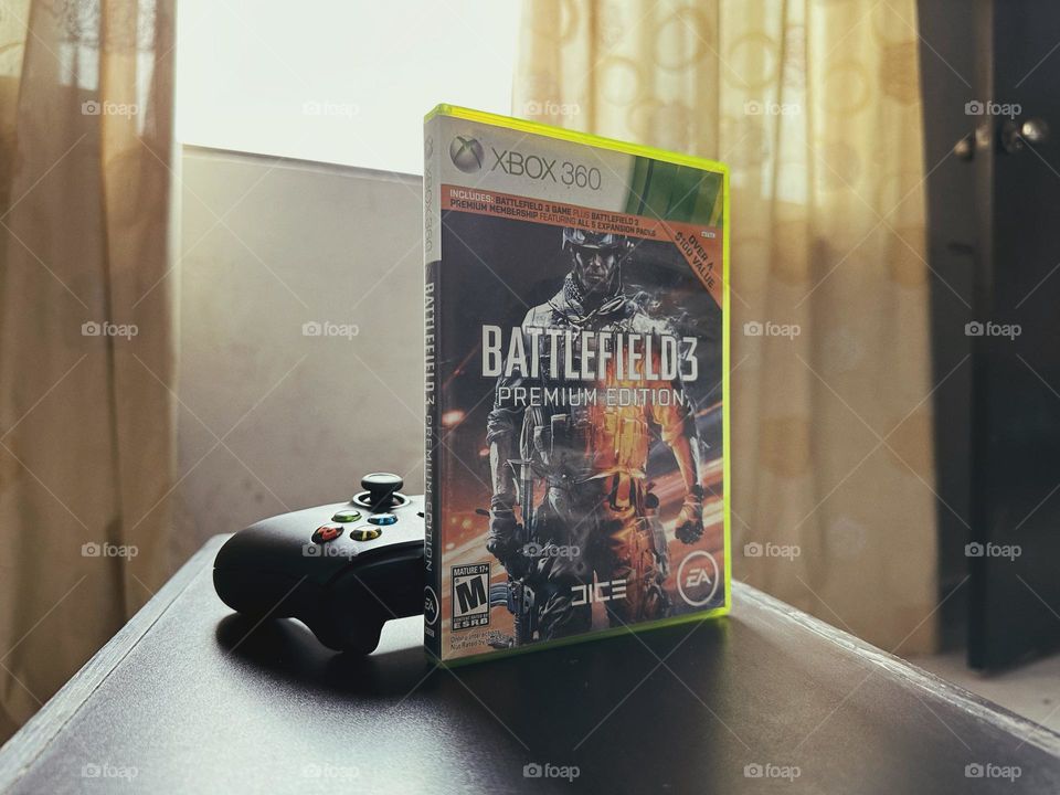 Battlefield video game box in front of a Xbox controller with natural light at the background.