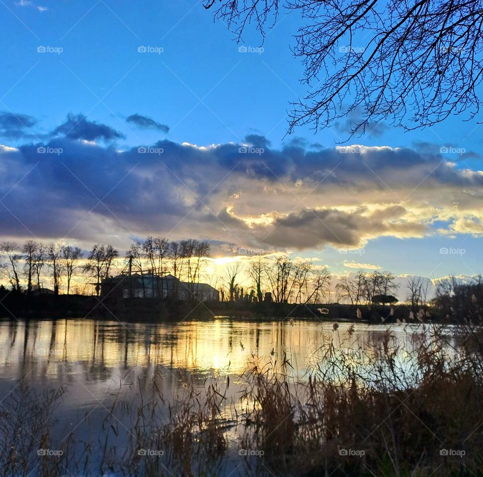 this photo is a sunset on the river