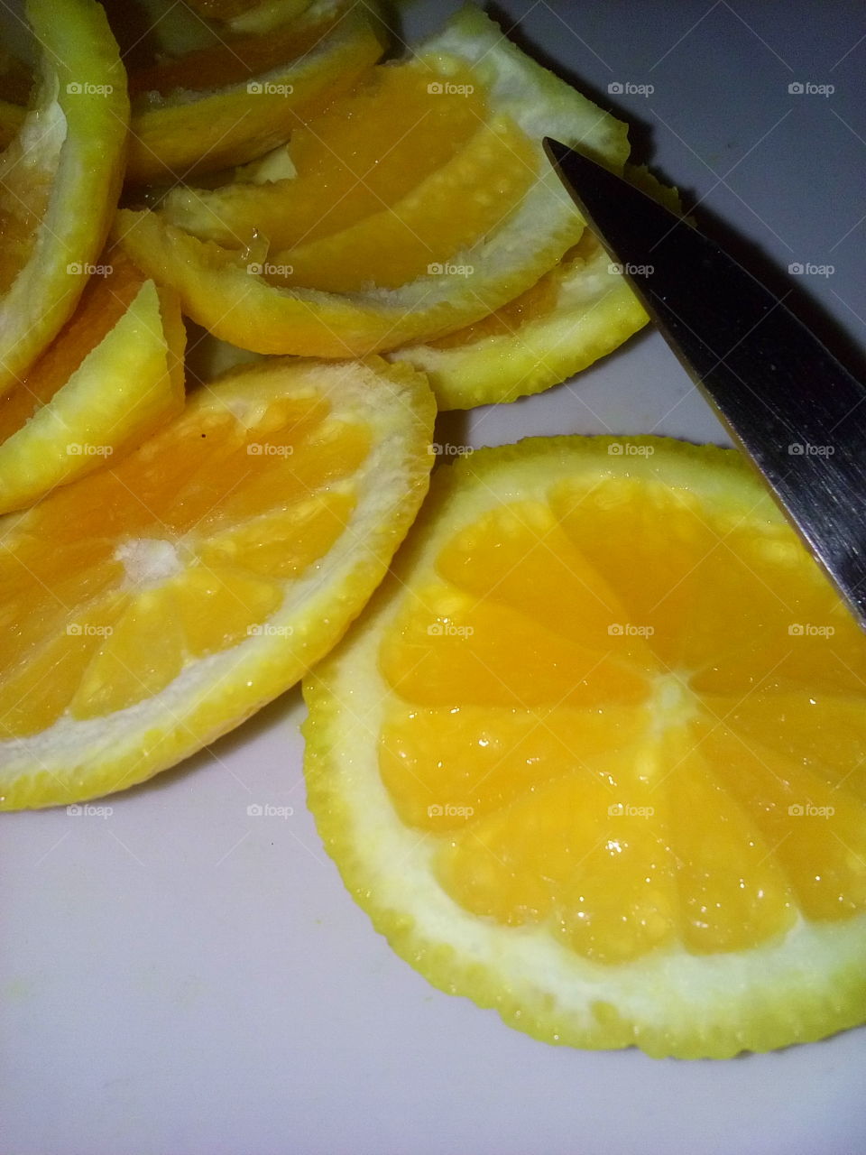 Cut Oranges & Tip of Knife