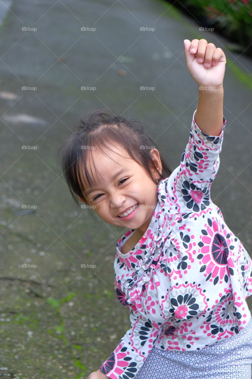 A playful and ginuine smile of a child is contagious. No fancy pose just fun 