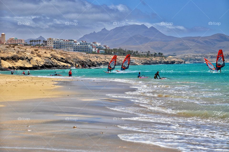 windsurfing in costa calma on fuerteventura canary island in spain - mountain and resort view
