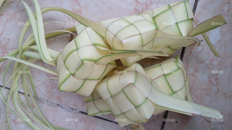 Making ketupat on the terrace of the house