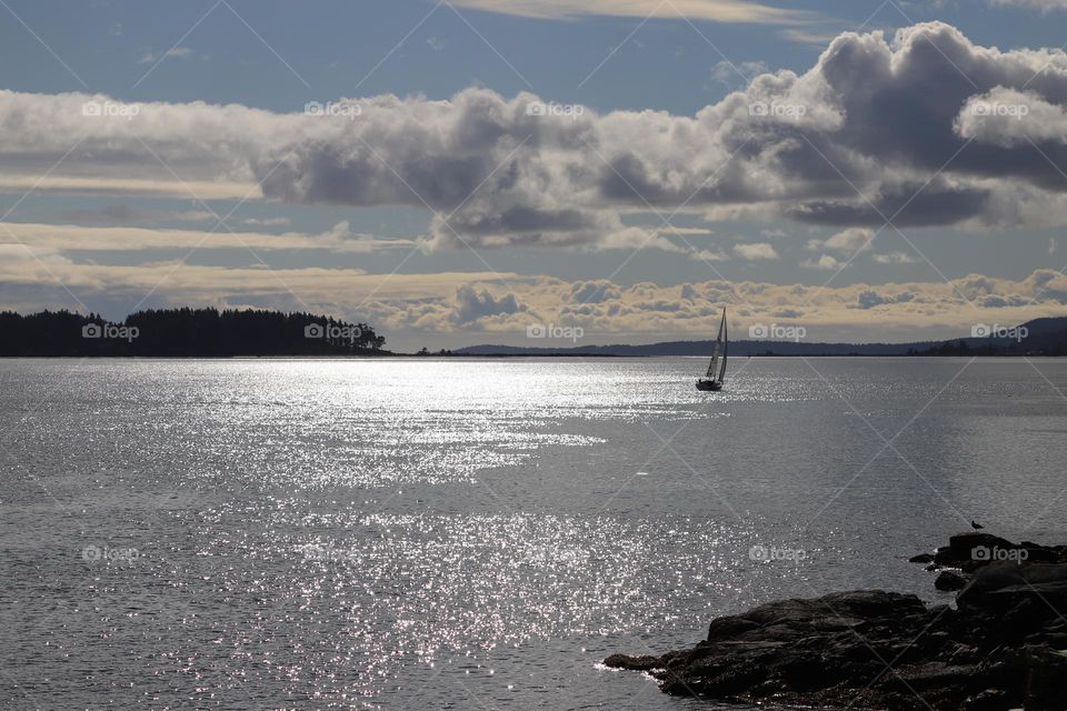 Sailing boat in calm ocean 