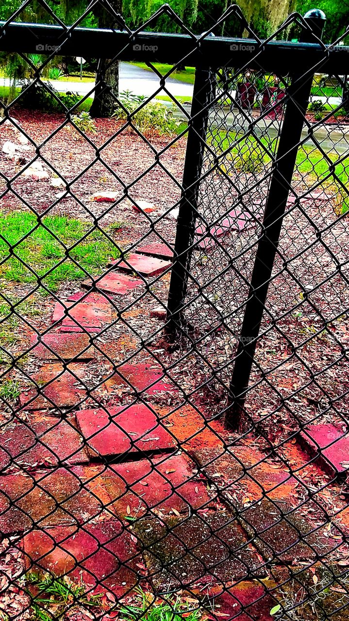 brick walkway chain link fence