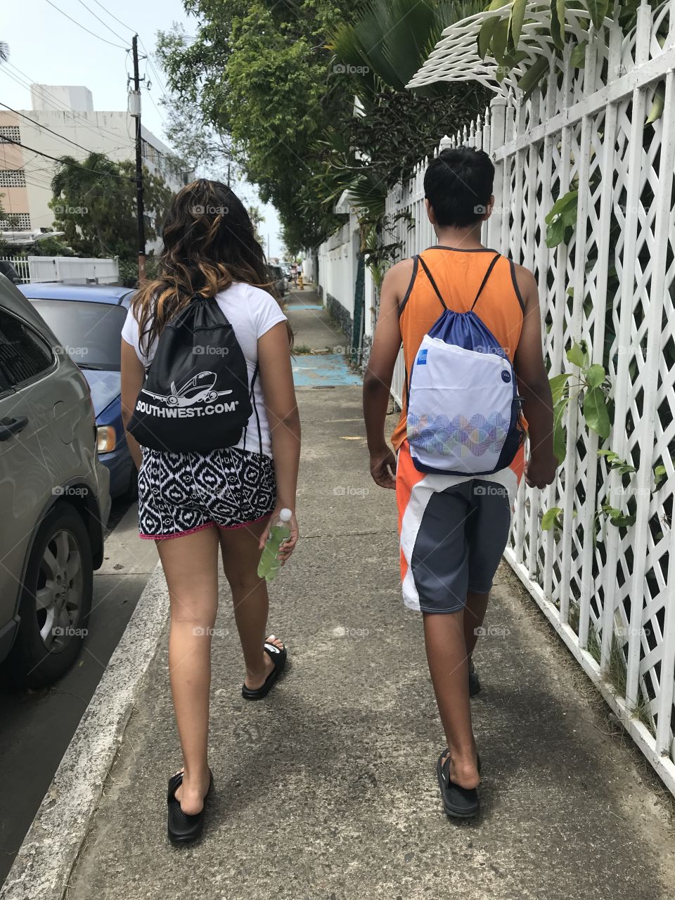Best Friends Forever. BFF. Boy and girl walking to the beach in a summer day. Island walkers with island fashion. 