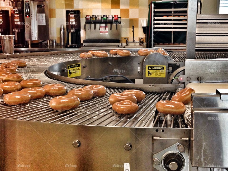 Conveyer of sweets. Doughnuts
On a conveyer at Krispy Kreme
