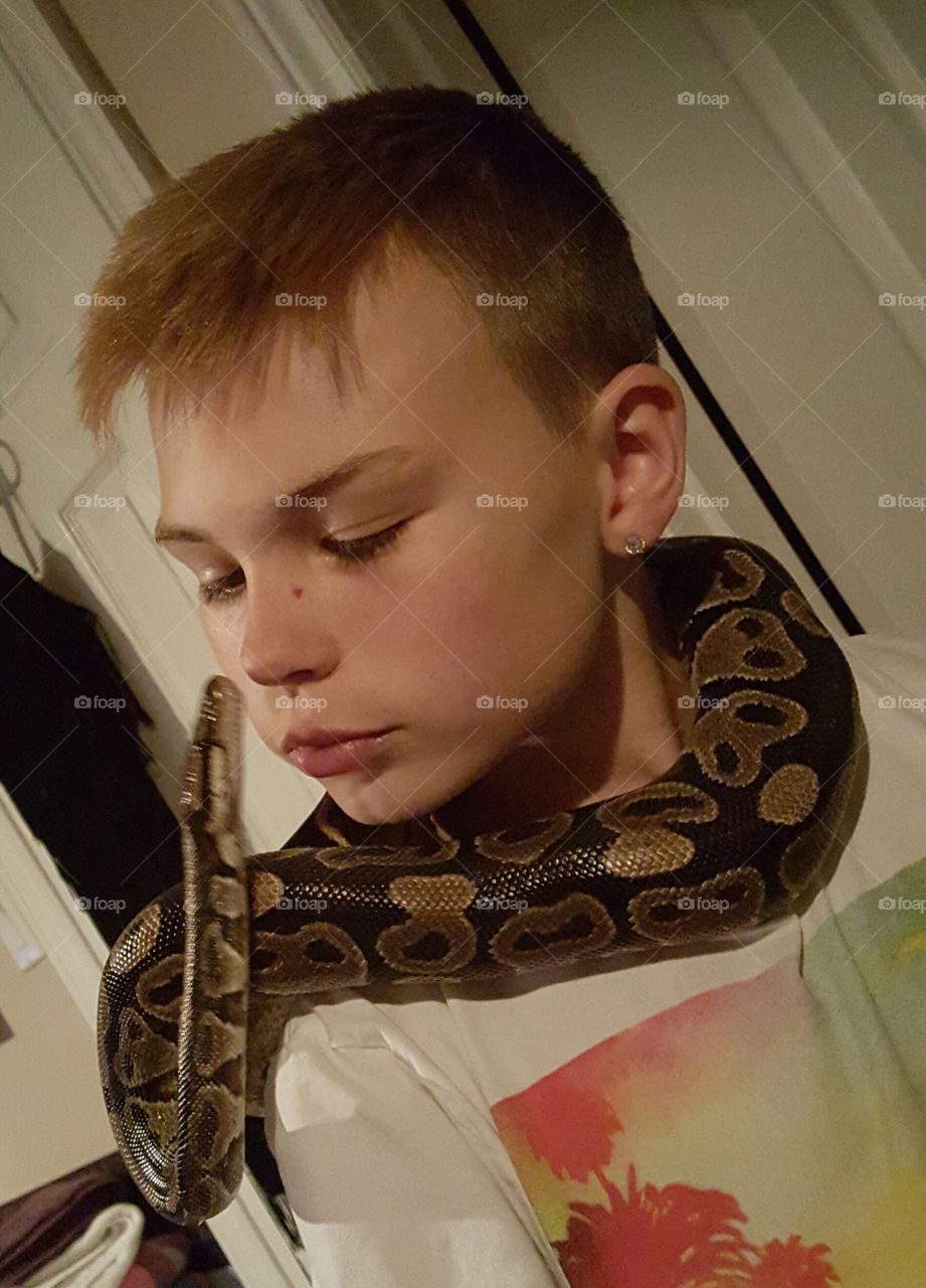 boy with ball python  around neck