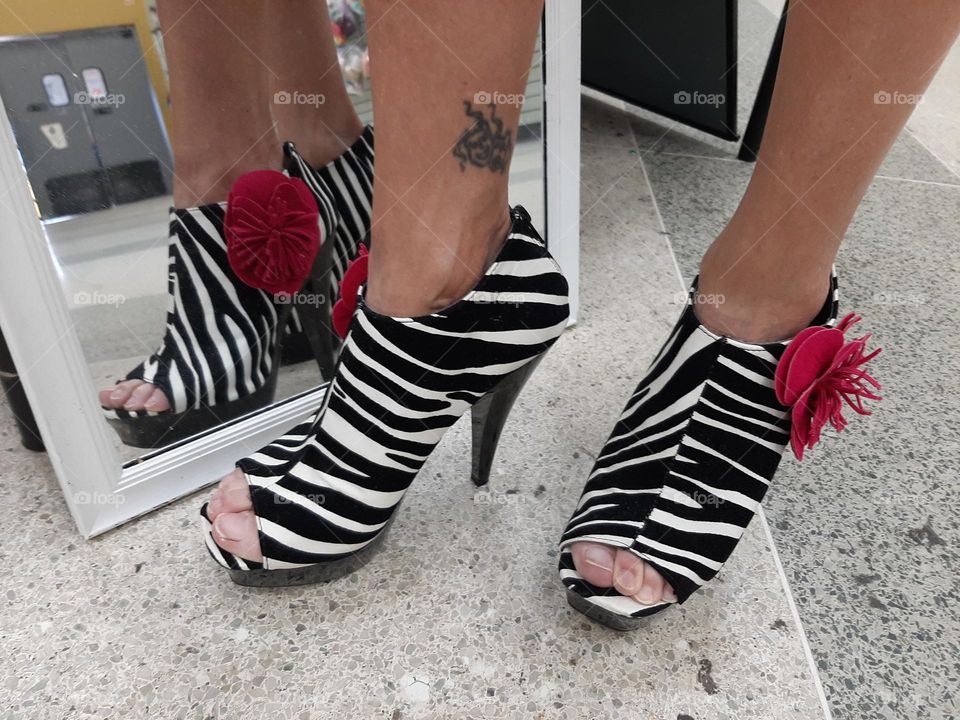 women shoes open toes zebra stile heels with bright fuchsia flower at the side.