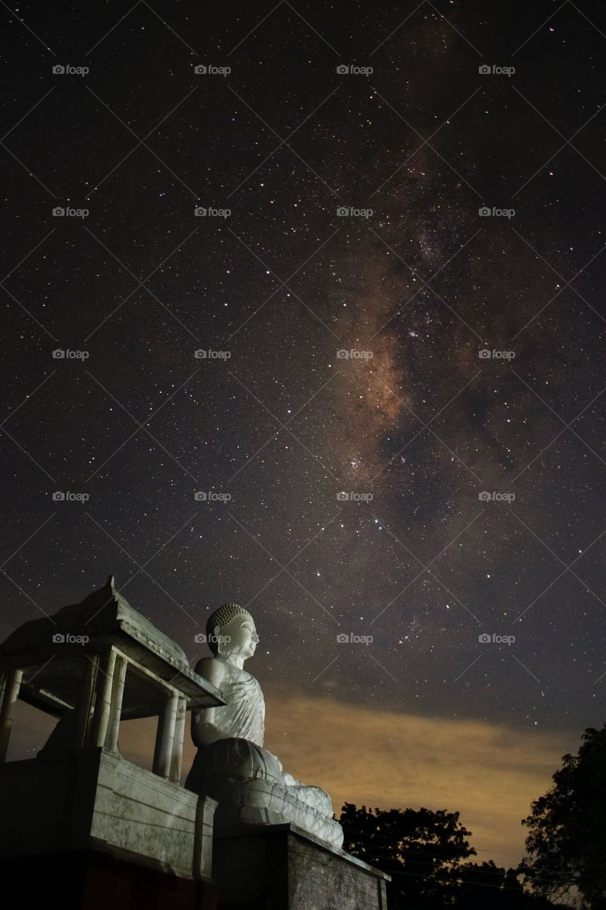 buddhist Statue with a beautiful evening sky