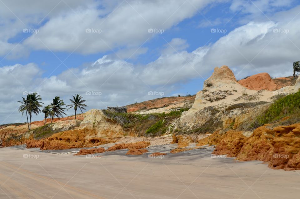 Multicoloured sand rocks near the beach.  Brazil 