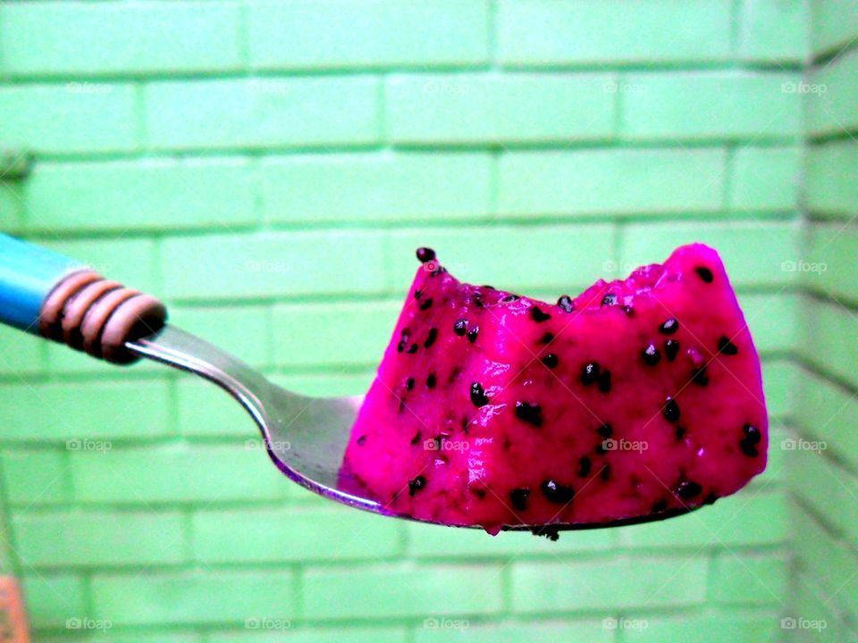 sliced dragon fruit on a spoon