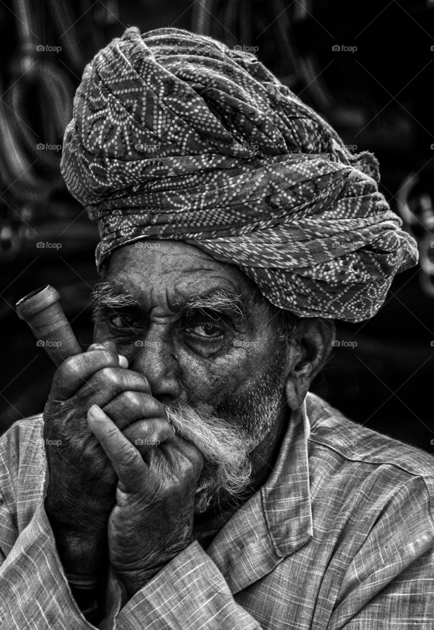 An old man is smoking