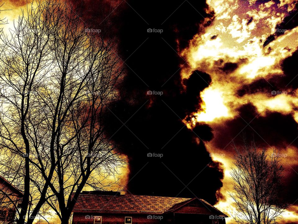 smoke rising behind building