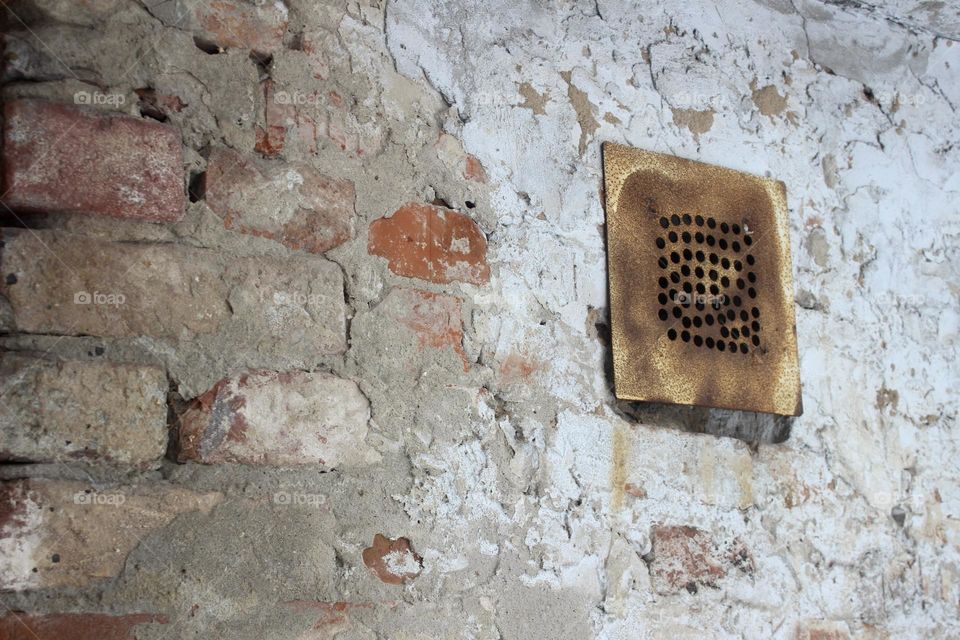Texture with grey and orange bricks with ventilation 