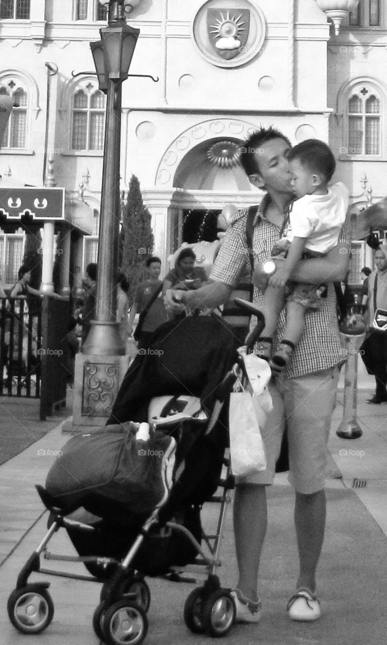 A father kissing his son on the cheek