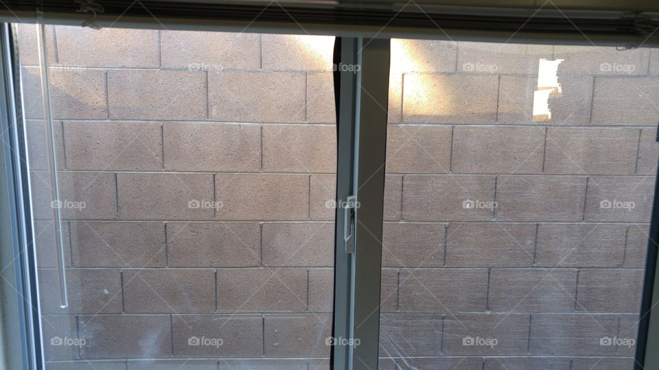 view of neighbors block wall