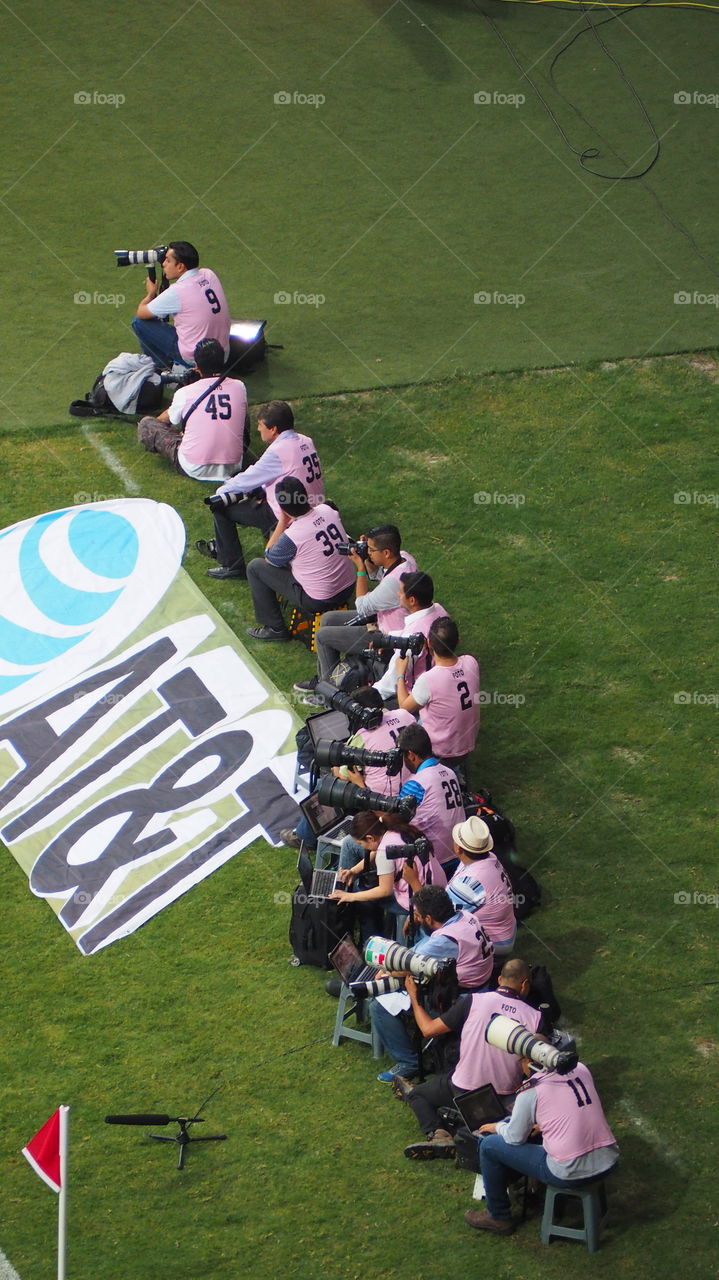 Press photographers at soccer. Press photographers at soccer field stadium shooting sports action activity